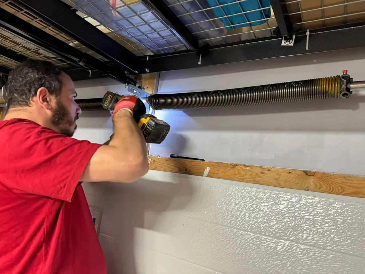 Jacob working on a garage door spring assembly
